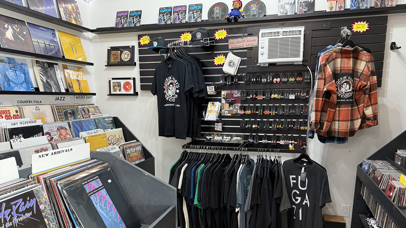 Store interior with apparel, earrings, and figurines on shelves at Rockin' Ruby's records on Bainbridge Island, WA